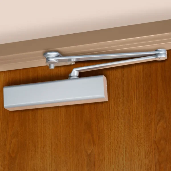 Norton 8501 Door Closer with CloserPlus Arm Norton CLP8501 door closer in 689 aluminum painted, mounted on the push side of a wood door: full cover closer body and stop-only CloserPlus parallel arm, its soffit plate fixed under the frame head